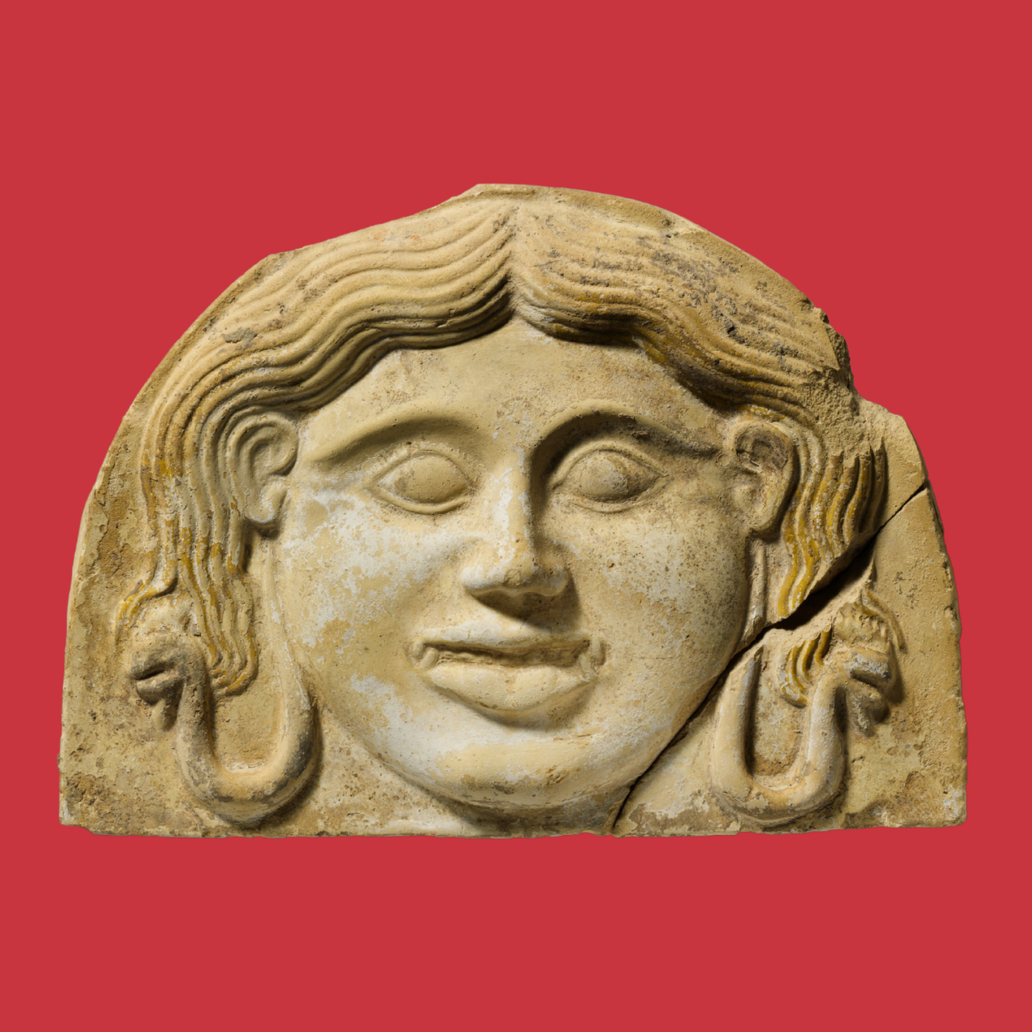 Digital print photo collage graphic. Tan stone carved image of the head mythical figure Medusa. Wavy hair with looped snakes at each shoulder grinning with fanged teeth. Red square background.